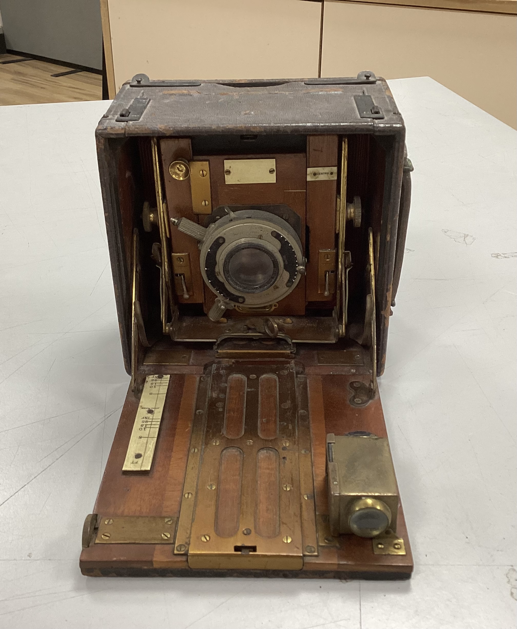 An Edwardian quarter plate camera, an early 20th century gilt decorated metal and Bakelite telephone, two Edwardian car lamps and a hand lamp etc.